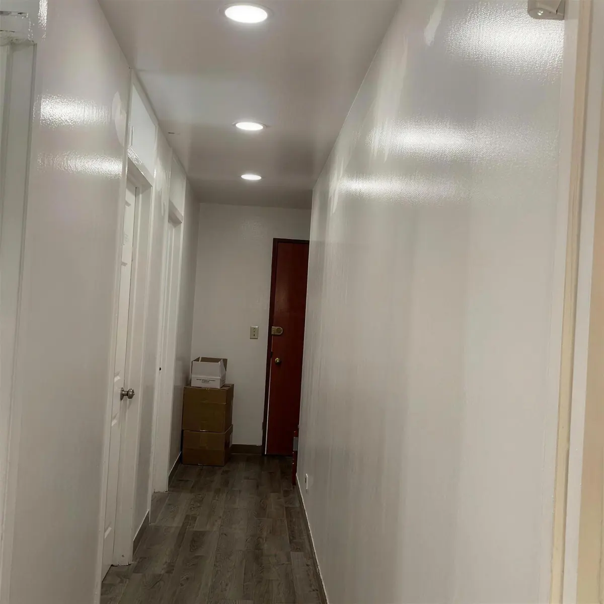 Después: el mismo pasillo con el techo reparado y pintado